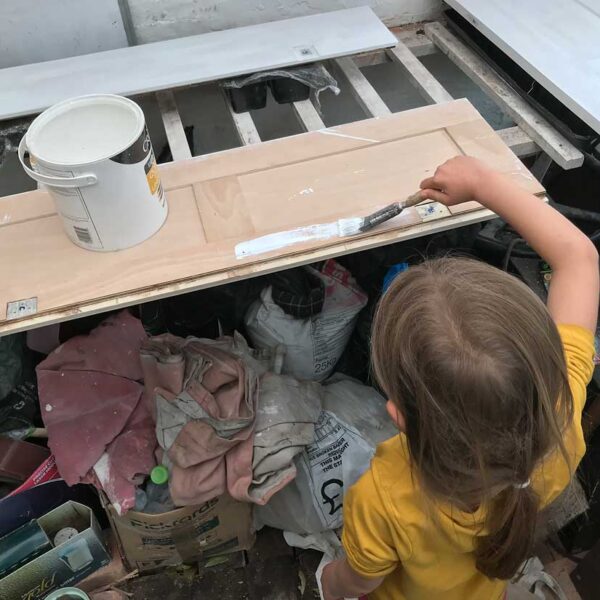 Lucy helps with the painting.