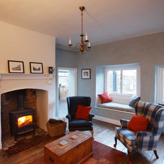 A fire roars in the Clearview stove in the Music Room, which overlooks the back garden
